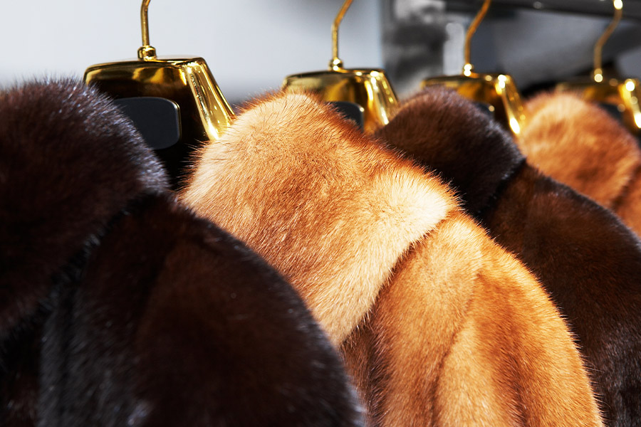 Furrier and Garment Dealer Insurance - Closeup of Vintage Fur Coats on a Sale Rack