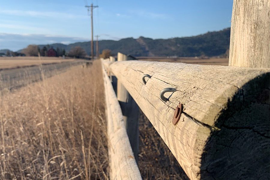 Insurance Quote - Closeup View of a Rustic Piece of Wooden Fence and Tall Grass During the Winter in Montana