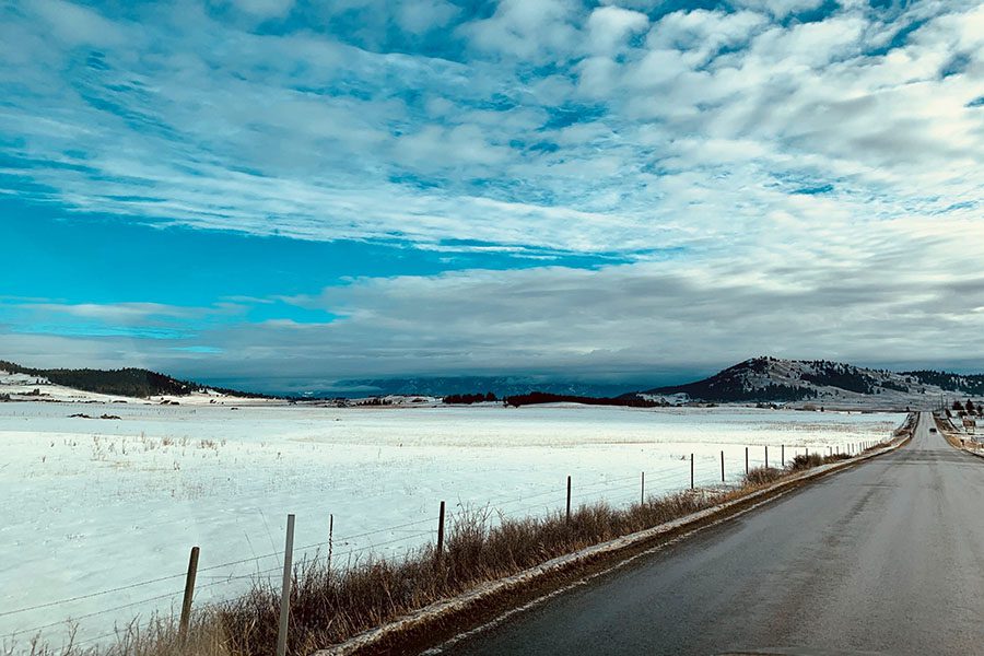 Join Our Team - View of an Empty Road Next to a Frozen Lake on a Cloudy Winter Day in Montana
