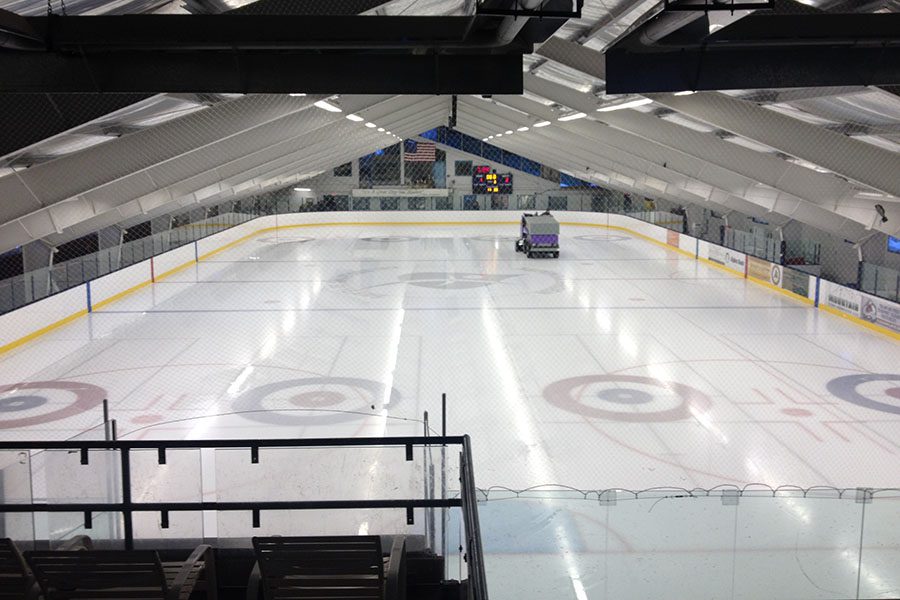 Specialized Business Insurance - View of an Empty Indoor Hockey Field with Bright Lights and an Ice Resurfacer