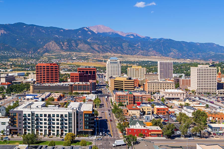 Colorado Springs, CO - Aerial View of Downtown Colorado Springs With Pikes Peak in the Background